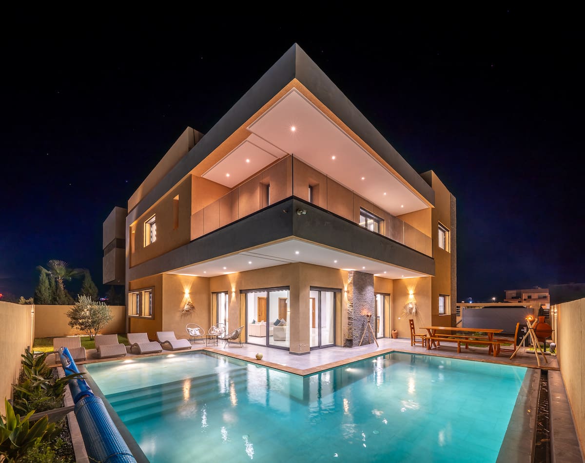 Marrakech retreat villa illuminated beside its private pool